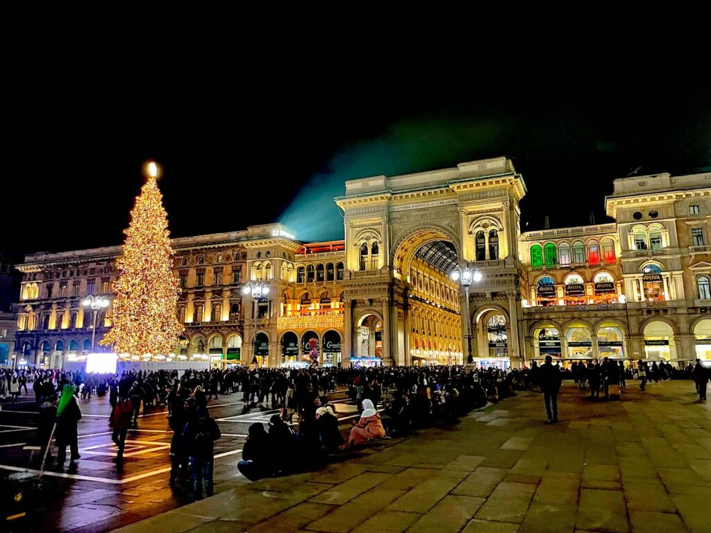 Milan's Christmas Trees: A stunning view of Piazza Duomo in 2023, showcasing a majestic Christmas tree with the Galleria Vittorio Emanuele II beautifully framed in the background