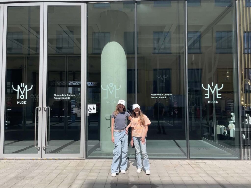 My daughters Gaia and Aurora in front of the glass entrance doors at Mudec