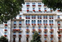 Hotel Principe di Savoia to Close in 2027: The Last Months to Stay Facade of Hotel Principe di Savoia in Milan, with red geraniums on the balconies