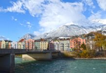 Frecciarossa Milan-Munich: New High-Speed Train Route Coming in 2027 Colourful houses on the bank of the Inn river in Innsbruck, Austria, a stop on the new Frecciarossa route from Milan to Munich