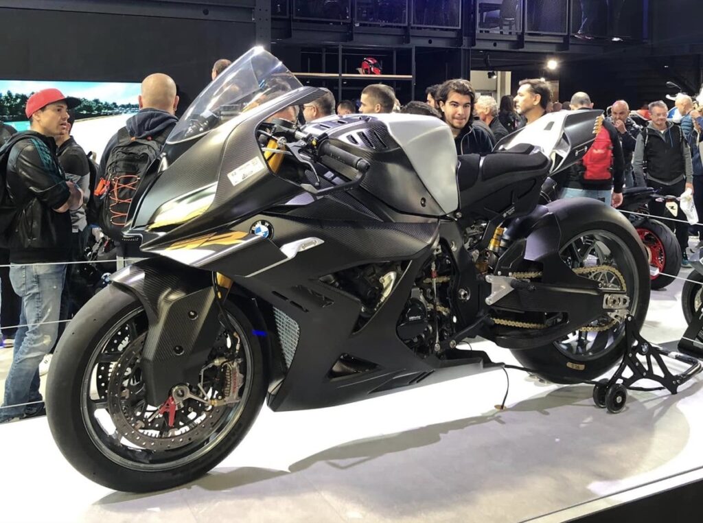 Visitors crowding around a BMW sport motorcycle on display at EICMA in Milan