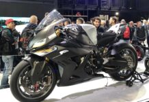 EICMA 2026 Milan: Dates, Tickets and How to Get There (November 5-8) Visitors crowding around a BMW sport motorcycle on display at EICMA in Milan