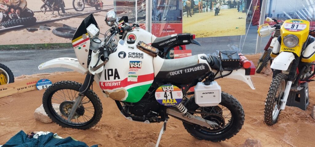 Cagiva Elefant 900 Dakar rally motorcycle on display on sand at EICMA in Milan